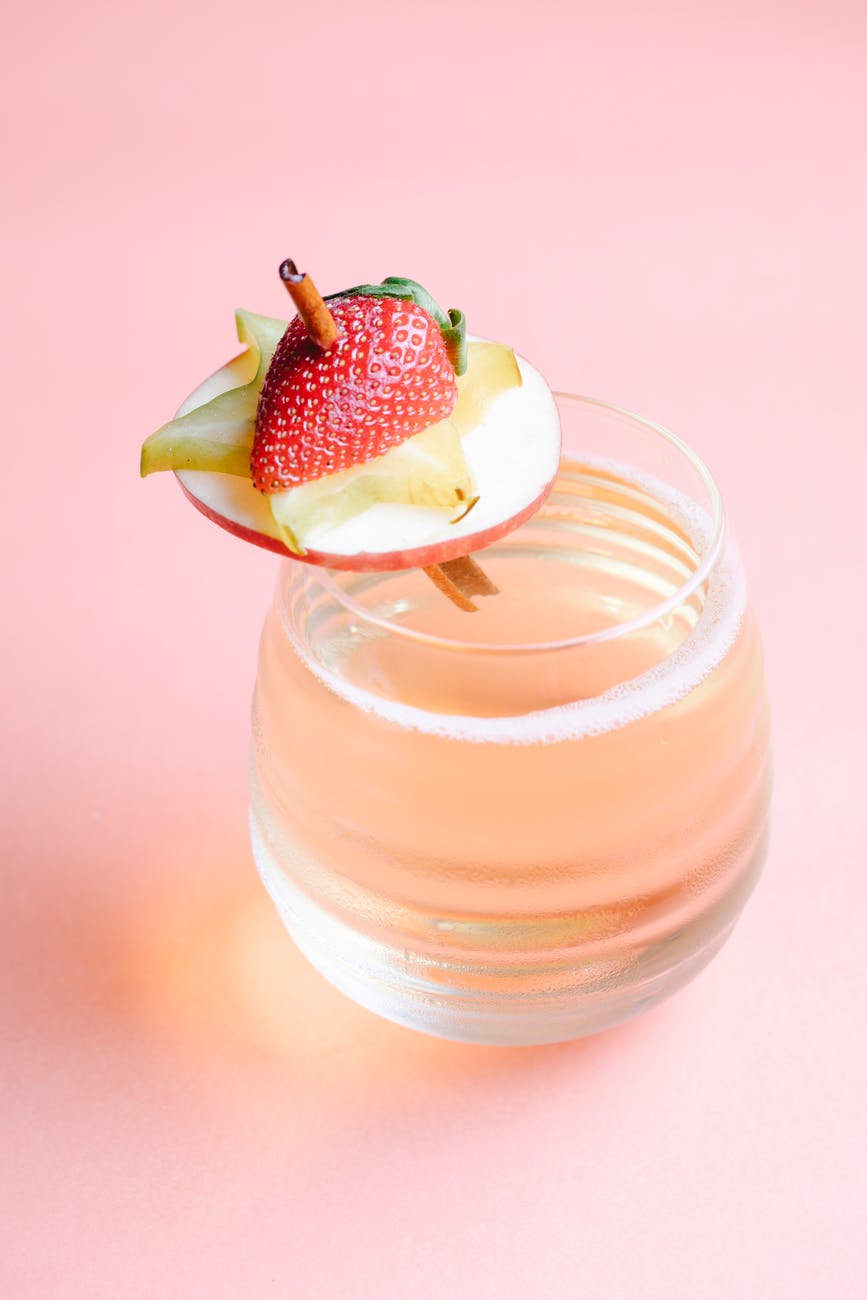 refreshing fruit cocktail decorated with slice of fresh strawberry and starfruit